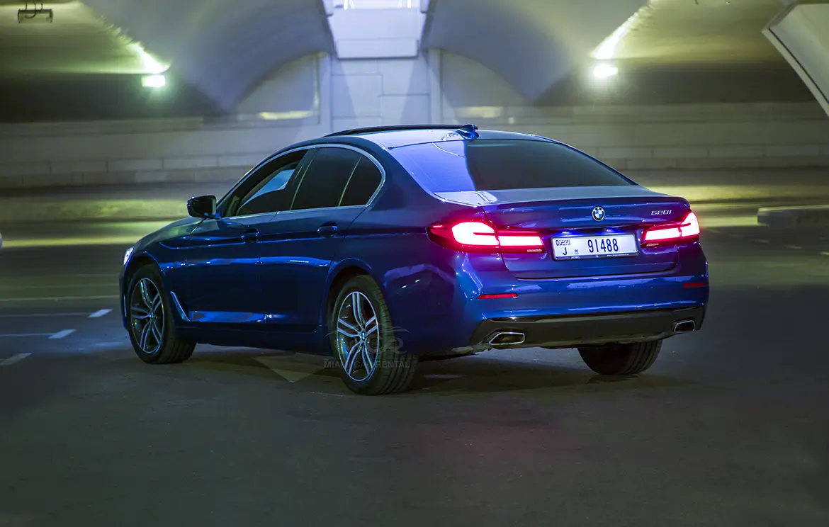 Rent the luxury blue BMW 520i sedan in Dubai